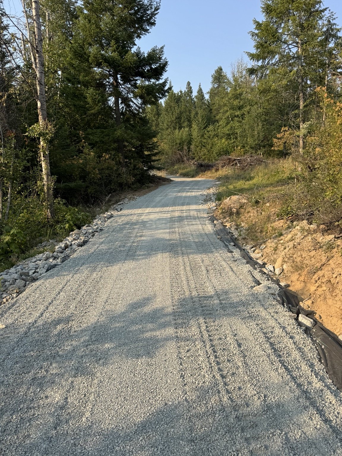 Finished gravel driveway through North Idaho forest
